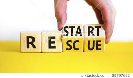 Restart and rescue symbol. Businessman hand turns cubes and changes the word 'recovery' to 'rescue'. Beautiful white background. Business, restart and rescue concept. Copy space. Restart and rescue symbol. Businessman hand turns cubes and changes the word 'recovery' to 'rescue'. Beautiful white background. Business, restart and rescue concept. Copy space. 89797632
