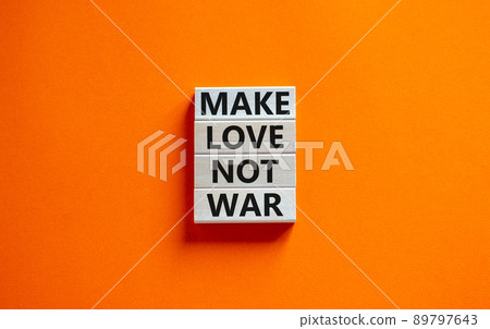 Make love not war symbol. Concept words Make love not war on wooden blocks. Beautiful orange table orange background. Make love not war business concept. Copy space. 89797643