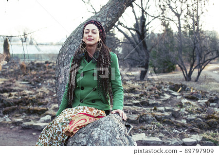 young adorable pretty girl with pigtails hairstyle smiling outside among trees close up 89797909