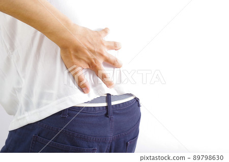 A man who puts his hand on his back sorely 89798630