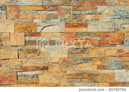 texture of a stone wall. Earth coloured slate stone background. Stone texture wall cladding for house wall. 89799708