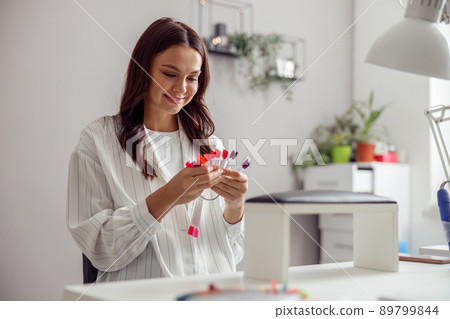 Caucasian woman enjoying nail service in beauty shop Caucasian woman enjoying nail service in beauty shop 89799844