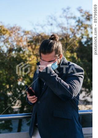 young business man gets bad news with face mask 89799869