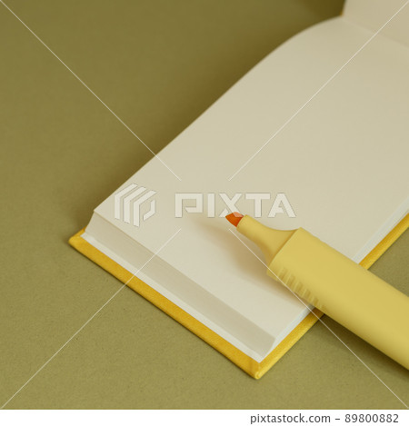 Open blank notebook and yellow highlighter on desk Open blank notebook and yellow highlighter on desk 89800882
