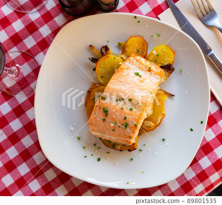 Dish of tasty baked salmon with onion and potatoes 89801535