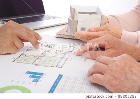 Senior couple considering while looking at the drawing of the house 89803282