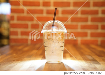 Take away Latte with Brick background on the wood table 89803465