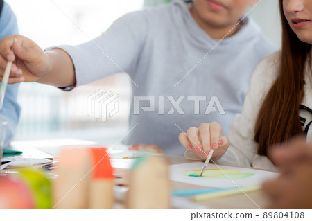 Closeup group of student sitting and studying and learning drawing with teacher together. Closeup group of student sitting and studying and learning drawing with teacher together. 89804108