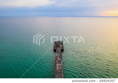 The jetty in the sea with the horizontal sea line by minimal drone photo shooting style in twilight time. Thailand. The jetty in the sea with the horizontal sea line by minimal drone photo shooting style in twilight time. Thailand. 89804267