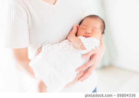 Hold a newborn baby, hold it sideways, copy space Hold a newborn baby, hold it sideways, copy space 89804336