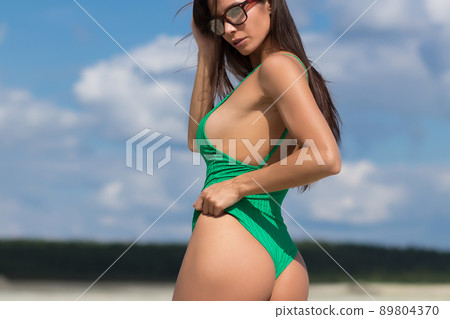 Slim lady in green swimming suit 89804370