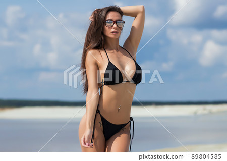 Beautiful woman in swimsuit on beach Beautiful woman in swimsuit on beach 89804585