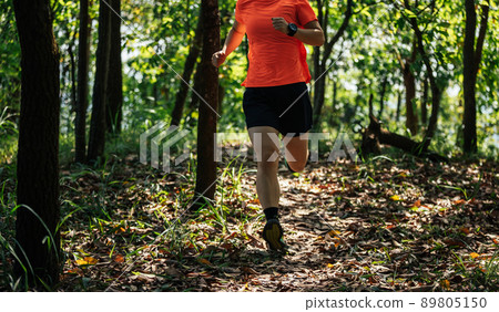 Woman runner running on forest trail 89805150