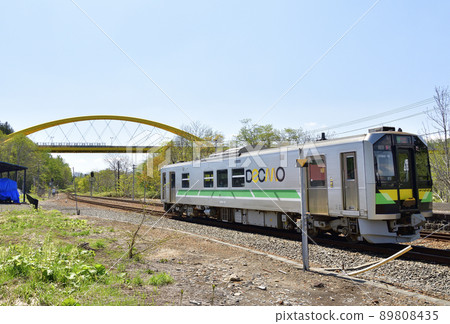 Photographing the scenery of a regular train departing from and arriving at JR Niseko Station in Niseko Town, Hokkaido in early summer 89808435