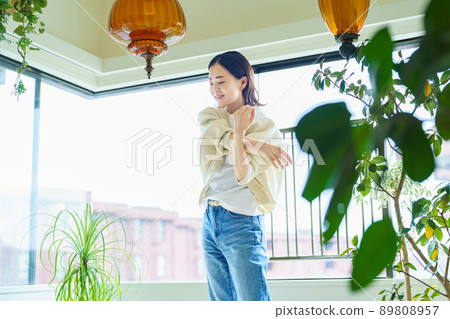 A woman stretching in her room 89808957