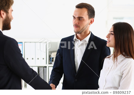 Couple shaking hands with realtor or lawyer, greet specialist in office Couple shaking hands with realtor or lawyer, greet specialist in office 89809237