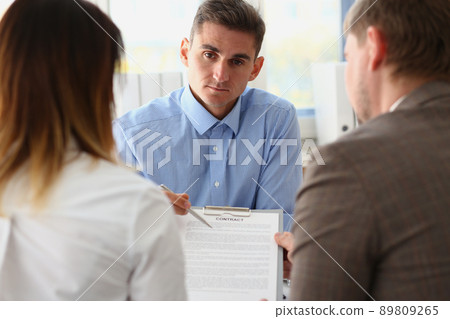Man worker in suit give contract paper to clients, agreement terms, put signature Man worker in suit give contract paper to clients, agreement terms, put signature 89809265