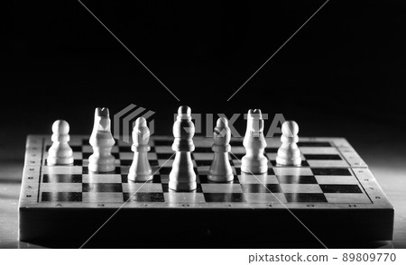 Composition with chessmen in the glossy chessboard 89809770