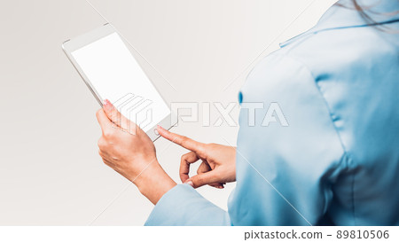 Young business woman using her touch on screen display computer tablet technology Young business woman using her touch on screen display computer tablet technology 89810506