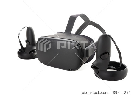 Close-up of a set of virtual reality devices. Joysticks and VR glasses isolated on a white background. Two controllers and a VR helmet. Side view. Close-up of a set of virtual reality devices. Joysticks and VR glasses isolated on a white background. Two controllers and a VR helmet. Side view. 89811255
