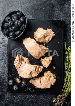 Foie gras duck liver pate and fresh blueberry. Black background. Top view 89812834