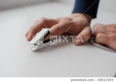 Pulse oximeter on a white background. Medical monitoring and diagnostic device for non-invasive measurement of capillary blood oxygen saturation Pulse oximeter on a white background. Medical monitoring and diagnostic device for non-invasive measurement of capillary blood oxygen saturation 89812904