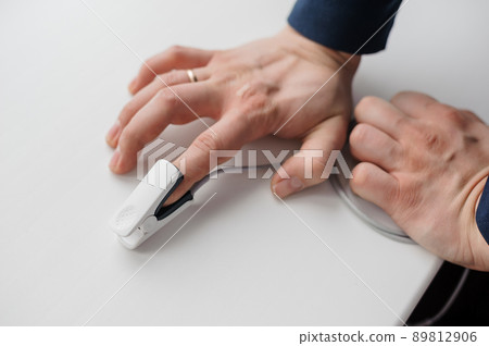 Pulse oximeter on a white background. Medical monitoring and diagnostic device for non-invasive measurement of capillary blood oxygen saturation 89812906