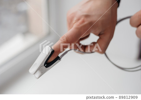Pulse oximeter on a white background. Medical monitoring and diagnostic device for non-invasive measurement of capillary blood oxygen saturation Pulse oximeter on a white background. Medical monitoring and diagnostic device for non-invasive measurement of capillary blood oxygen saturation 89812909