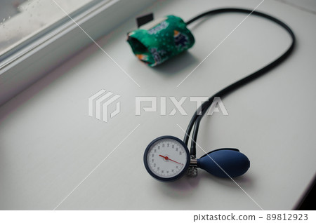 Tonometer on a white background. Diagnostic device for determining blood pressure and pulse rate Tonometer on a white background. Diagnostic device for determining blood pressure and pulse rate 89812923