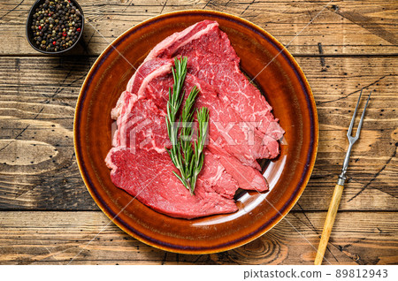 Raw beef meat chop rump steak on a plate. wooden background. Top view Raw beef meat chop rump steak on a plate. wooden background. Top view 89812943