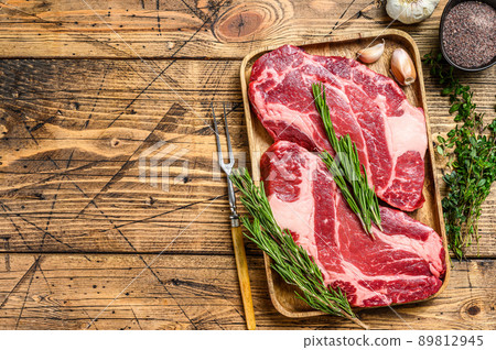 Fresh Raw Black Angus prime beef chuck eye roll steaks. wooden background. Top view. Copy space Fresh Raw Black Angus prime beef chuck eye roll steaks. wooden background. Top view. Copy space 89812945
