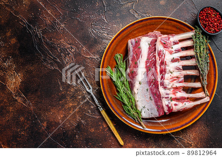 Raw Racks of lamb ready for cooking. Dark background. Top view. Copy space 89812964
