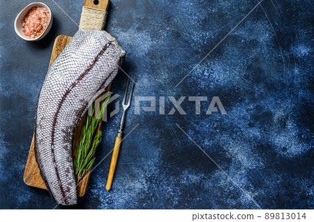 Fresh Raw grenadier macrurus white fish on a wooden cutting board. Blue background. Top view. Copy space Fresh Raw grenadier macrurus white fish on a wooden cutting board. Blue background. Top view. Copy space 89813014