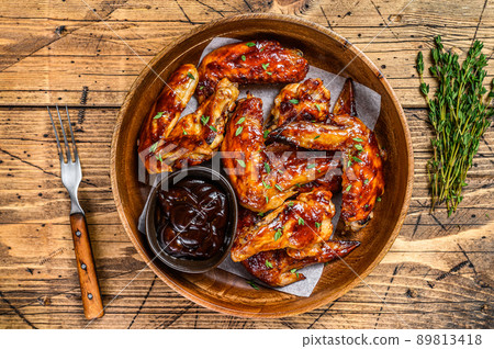 Grilled chicken wings with bbq sauce. wooden background. Top view Grilled chicken wings with bbq sauce. wooden background. Top view 89813418