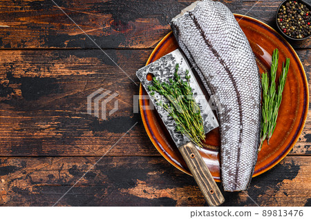 Fresh Raw grenadier macrurus white fish without head. Dark Wooden background. Top view. Copy space 89813476