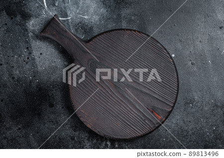 Cooking background with old empty cutting board. Black background. Top view. Copy space Cooking background with old empty cutting board. Black background. Top view. Copy space 89813496