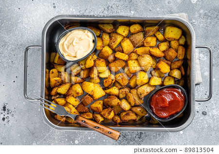 Patatas bravas traditional Spanish potatoes snack tapas in a steel tray. Gray background. Top view 89813504