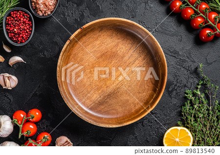 Healthy eating vegan food concept background with empty plate and fresh seasoning, herbs and ingredients. Black background. Top view. Copy space 89813540