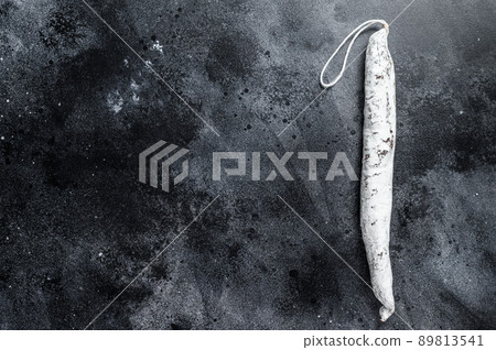 Spanish salami fuet sausage on a kitchen table. Black background. Top view. Copy space Spanish salami fuet sausage on a kitchen table. Black background. Top view. Copy space 89813541