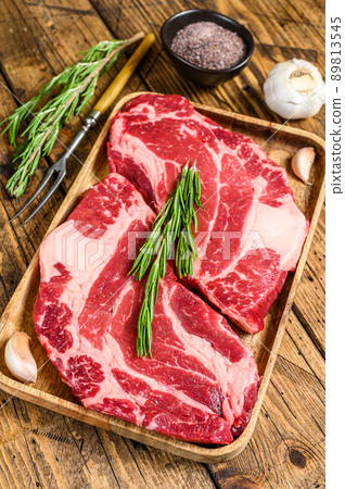 Fresh Raw Black Angus prime beef chuck eye roll steaks. wooden background. Top view Fresh Raw Black Angus prime beef chuck eye roll steaks. wooden background. Top view 89813545