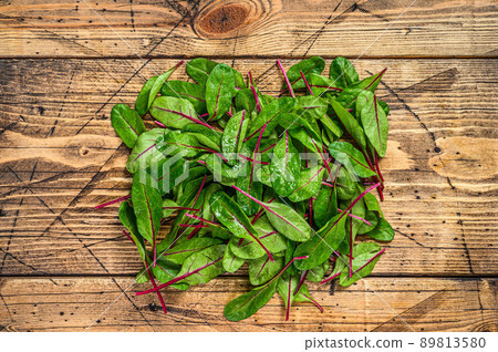 Fresh raw chard leaves, mangold, swiss chard on a wooden kitchen table. Wooden background. Top view Fresh raw chard leaves, mangold, swiss chard on a wooden kitchen table. Wooden background. Top view 89813580