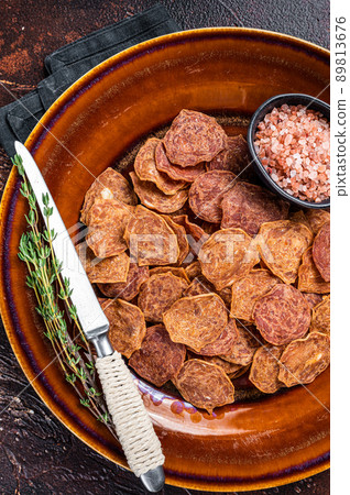 Dried smoked Meat Jerky from beef and pork meat. Dark background. Top view 89813676