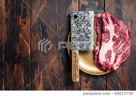 Raw marbled meat Steak on butcher table, uncooked beef chuck eye roll steak. Wooden background. Top view. Copy space 89813739