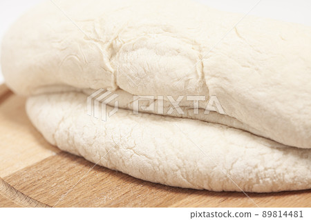 Fresh yeast dough on cutting board Fresh yeast dough on cutting board 89814481