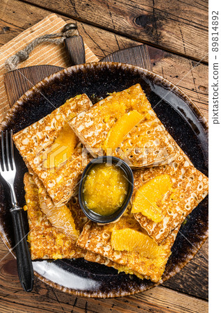 Traditional French crepe Suzette with orange sauce on a plate. Wooden background. Top view 89814892