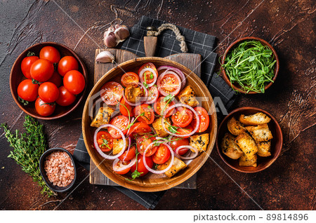 Tuscan Panzanella salad, Vegetarian classic salad with tomatoes, onion and Croutons. Dark background. Top view 89814896