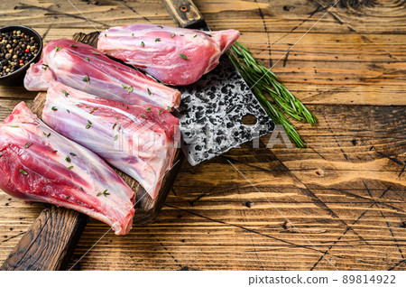 Fresh Raw goat shanks meat with herbs and pepper. wooden background. Top view. Copy space Fresh Raw goat shanks meat with herbs and pepper. wooden background. Top view. Copy space 89814922