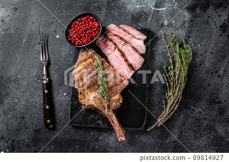 Grilled Tomahawk Beef Steak, Rib eye with thyme. Black background. Top view 89814927