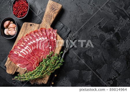 Sliced Turkish bacon Pastrami, roasted beef meat. Black background. Top view. Copy space Sliced Turkish bacon Pastrami, roasted beef meat. Black background. Top view. Copy space 89814964