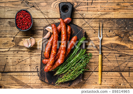 Pork Smoked sausages with addition of fresh aromatic herbs and spices. wooden background. Top view Pork Smoked sausages with addition of fresh aromatic herbs and spices. wooden background. Top view 89814965